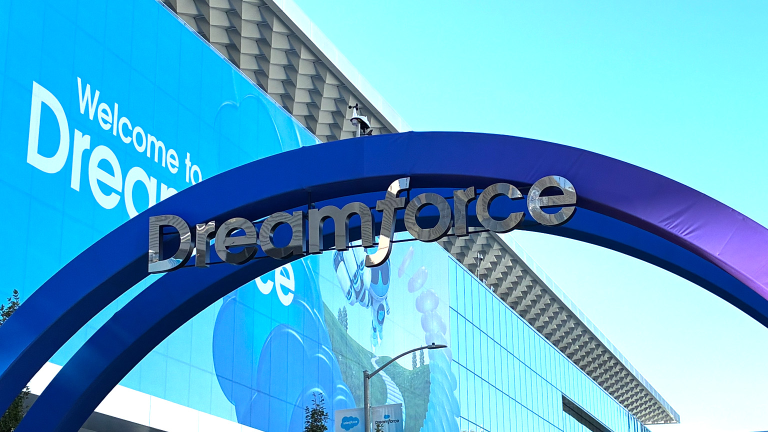 Entrance to Dreamforce, with a large blue arch and “Dreamforce” signage outside the conference venue.