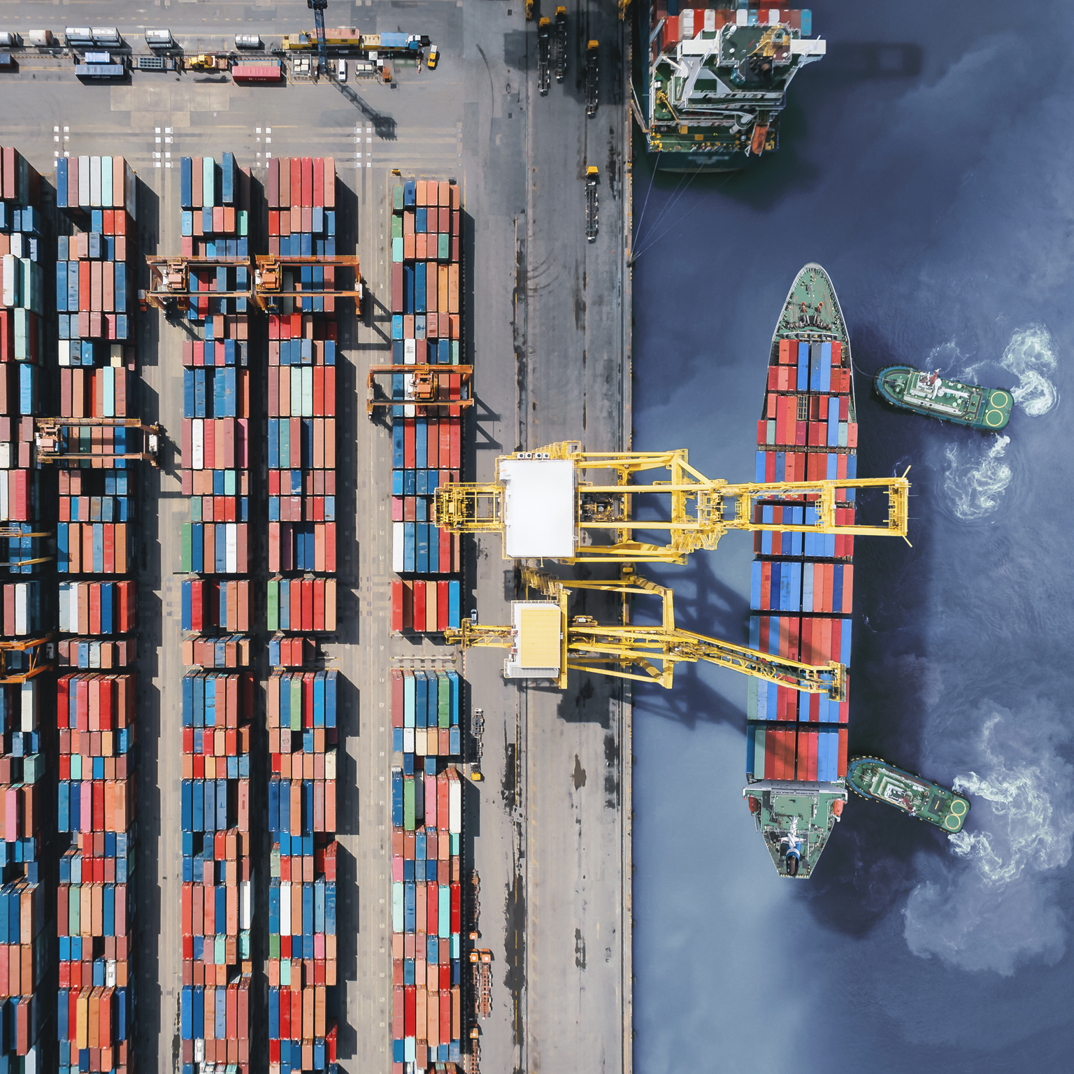 Aerial view of cargo ship getting unloaded