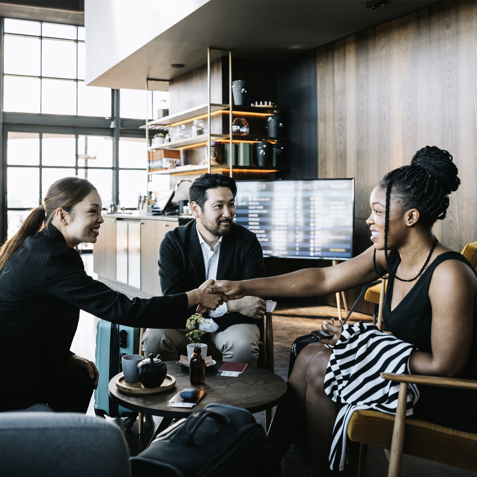 Three people greeting each other