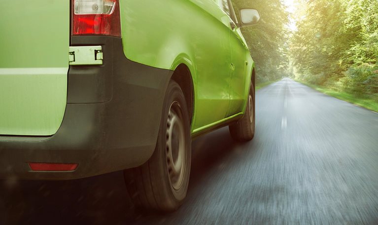 Sustainable freight transport vehicle driving down road