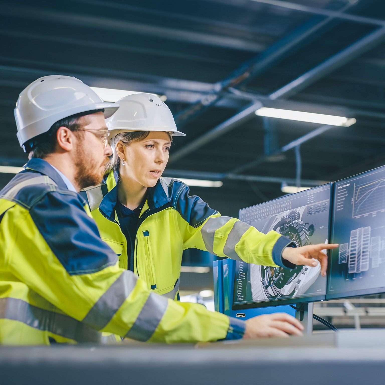 Inside Factory Male Mechanical Engineer and Female Chief Engineer Work Together on the Personal Computer, They Discuss Details of the 3D Engine Model Design.