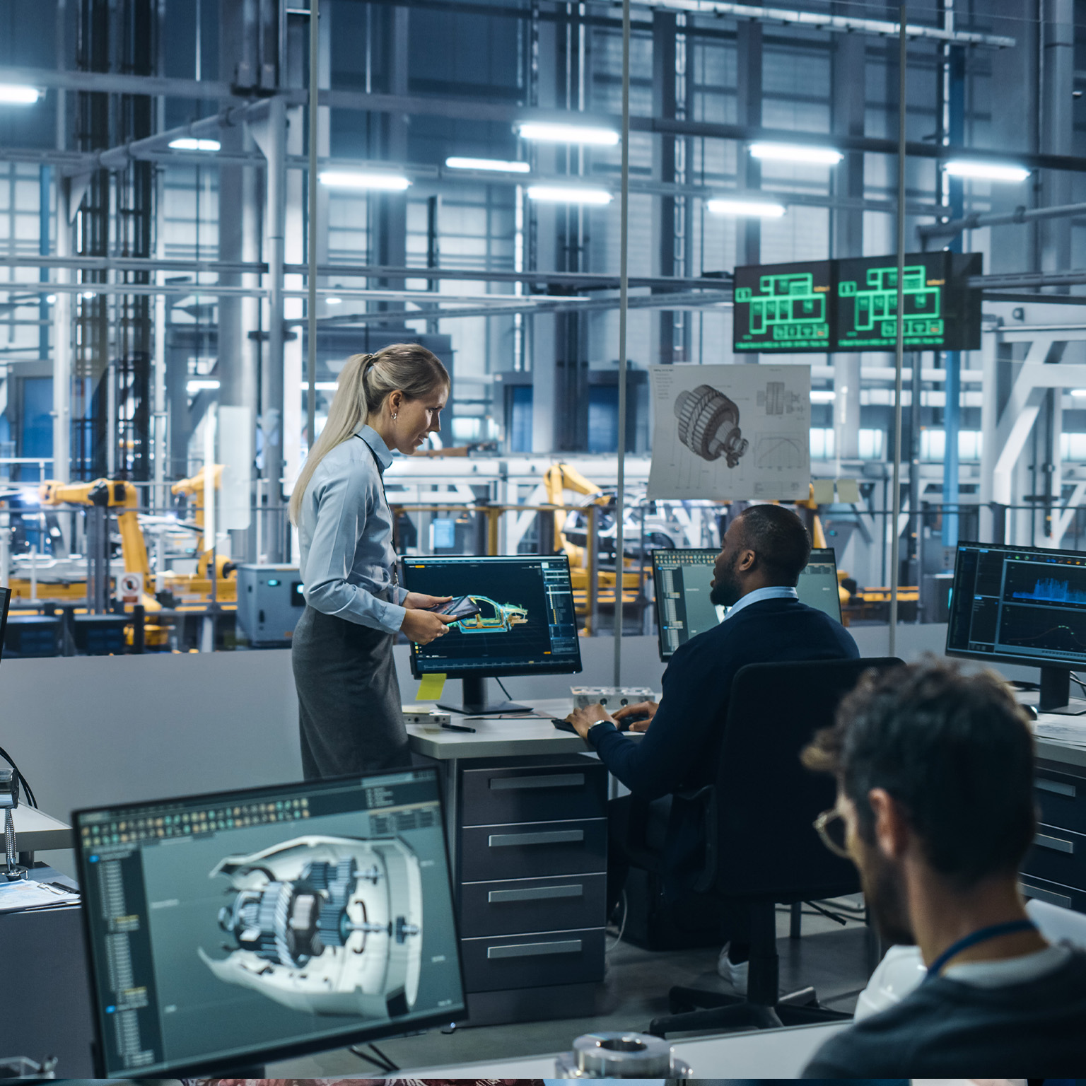 Car Factory: Team of Automotive Engineers Working, Using Computers to Design Advanced 3D Models for High-Tech Engines. Automated Robot Arm Industrial Assembly Line Manufacturing Electric Vehicles - stock photo