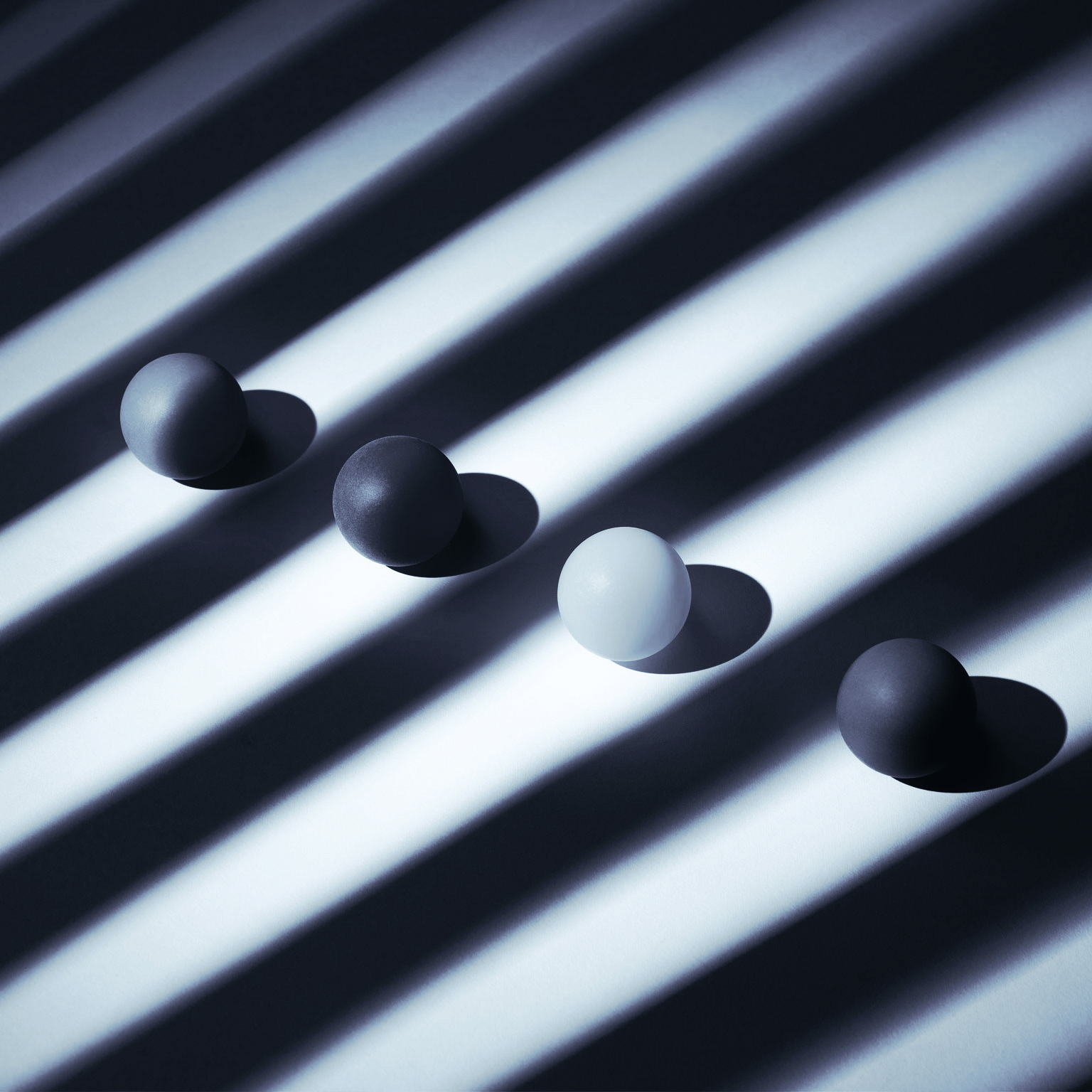 Photo of balls in a row on striped background