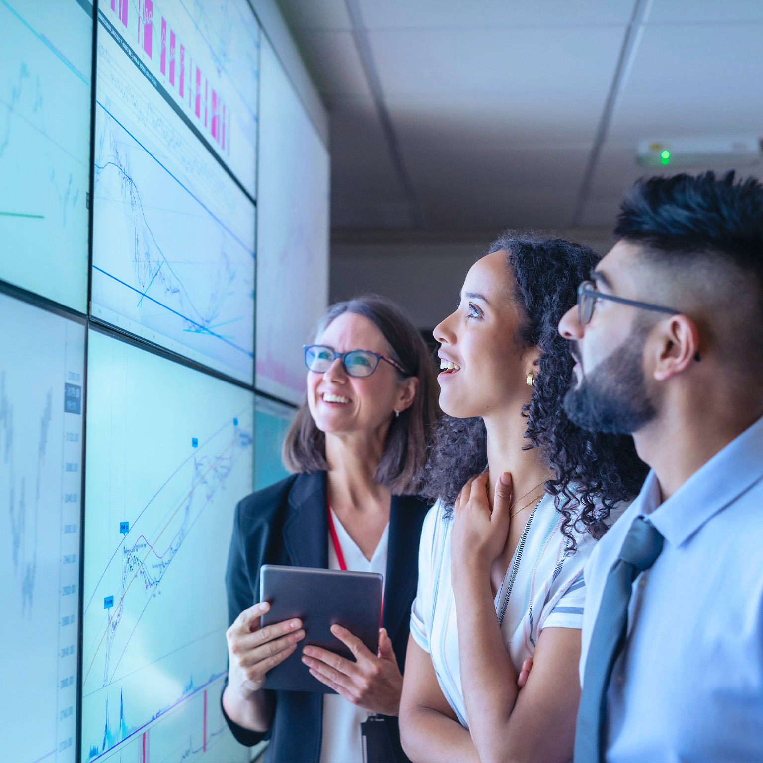 UK, York, Business people discussing charts on interactive screens