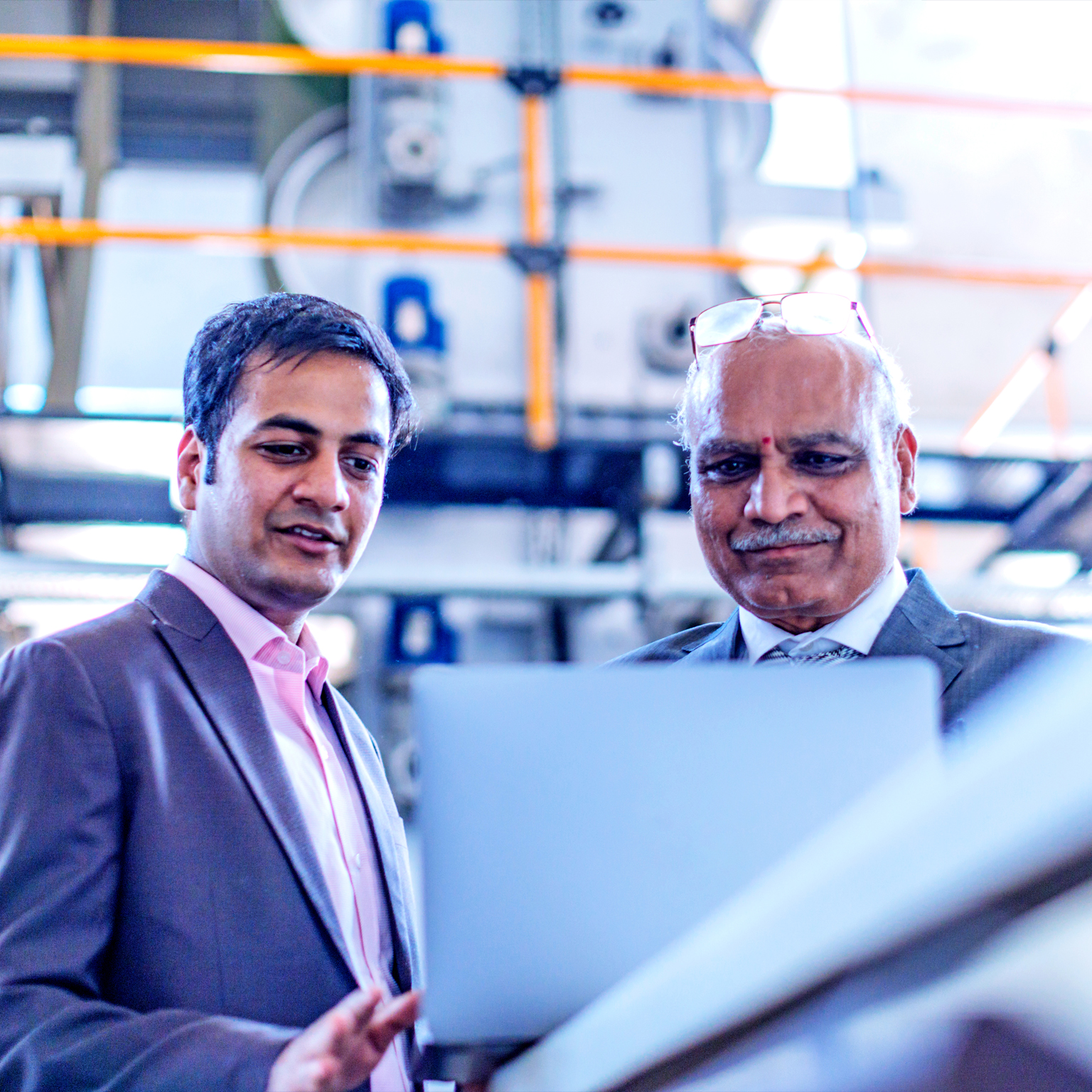 Two men looking at a laptop screen