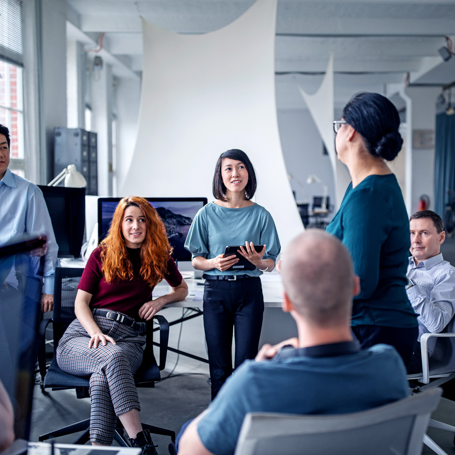 Employees in an effective resource group of people in an informal meeting in an office set-up
