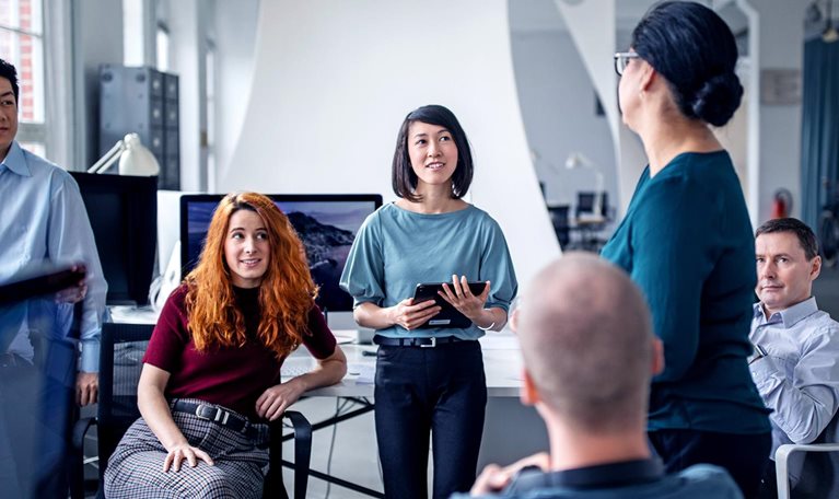 Employees in an effective resource group of people in an informal meeting in an office set-up