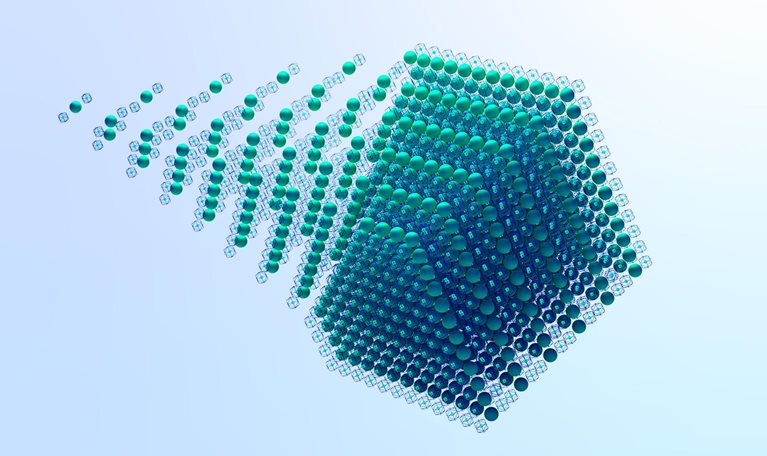 A visually striking image of a cube made of green spheres within wireframe boxes, with a sense of movement as the spheres seem to be trailing off from the main cube.