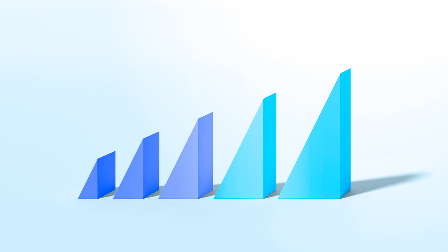 Colorful triangle shapes on pastel background increasing in size to illustrate growth