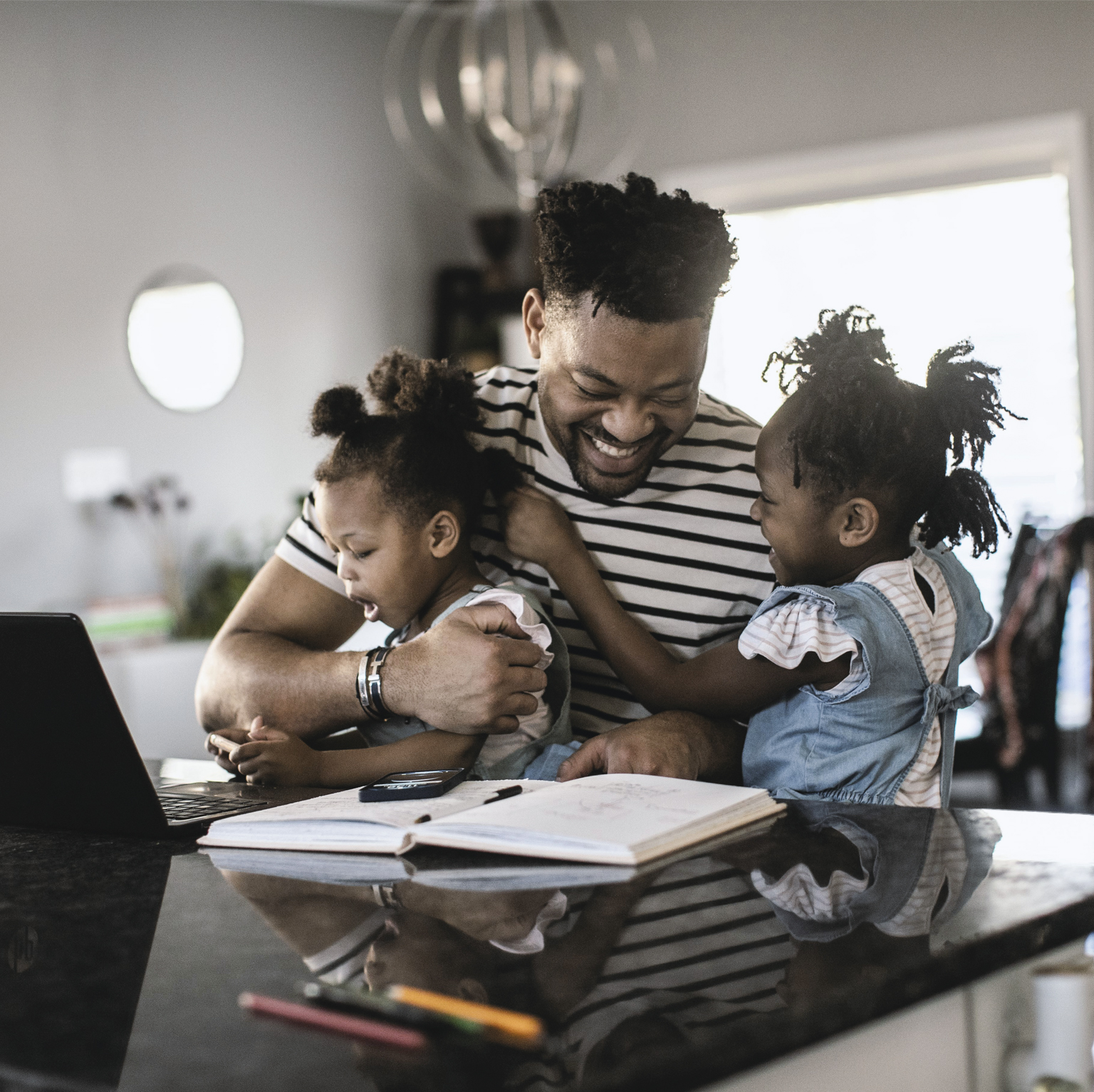 Working dad hugging kids