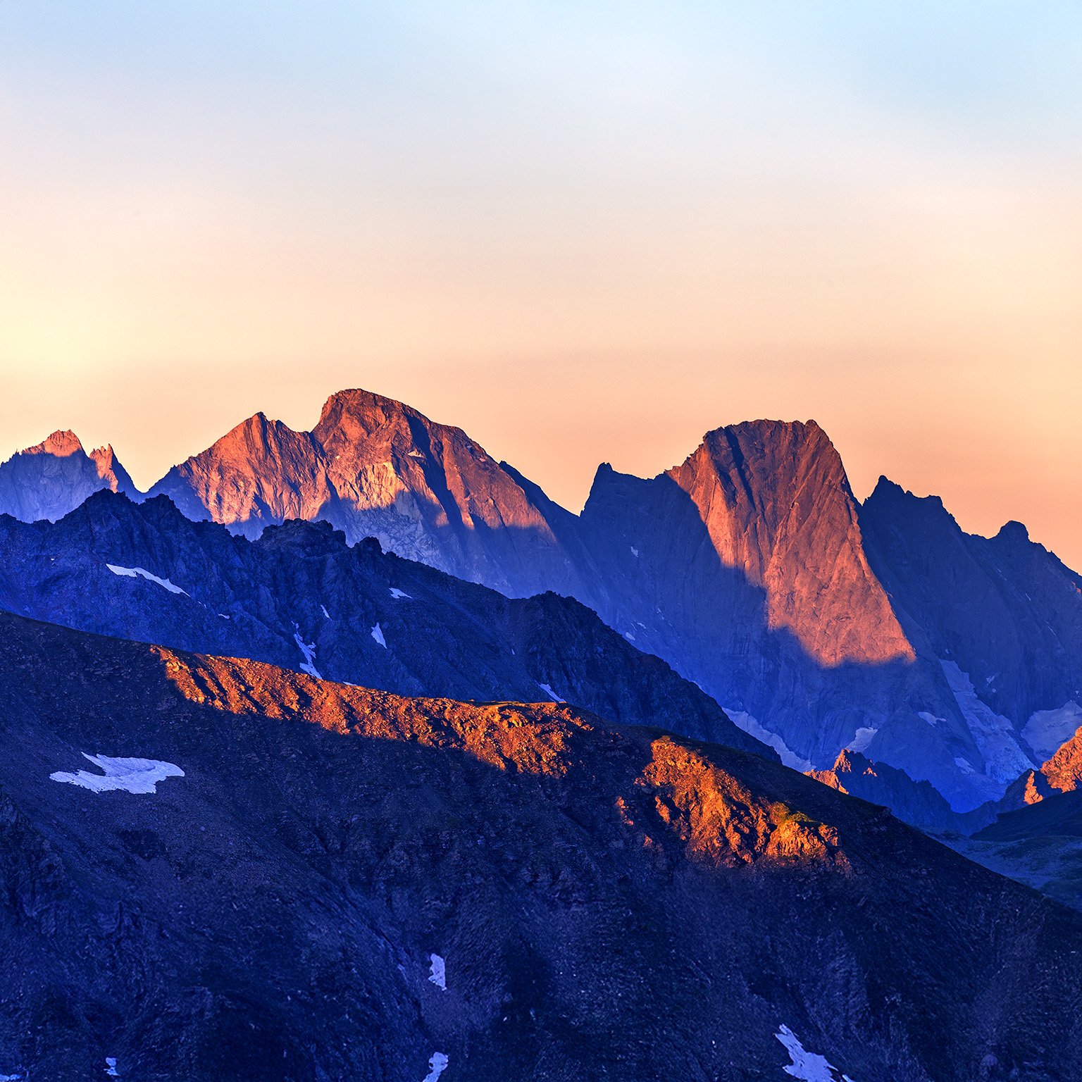 An image of a majestic mountain ridge-line at first light.