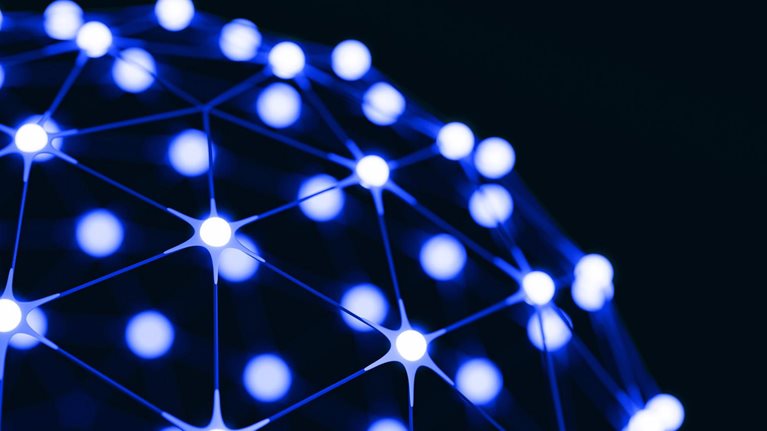 An abstract network of glowing blue-white nodes connected by thin lines across a dark background, forming part of a spherical structure.