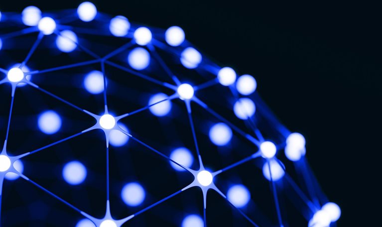 An abstract network of glowing blue-white nodes connected by thin lines across a dark background, forming part of a spherical structure.