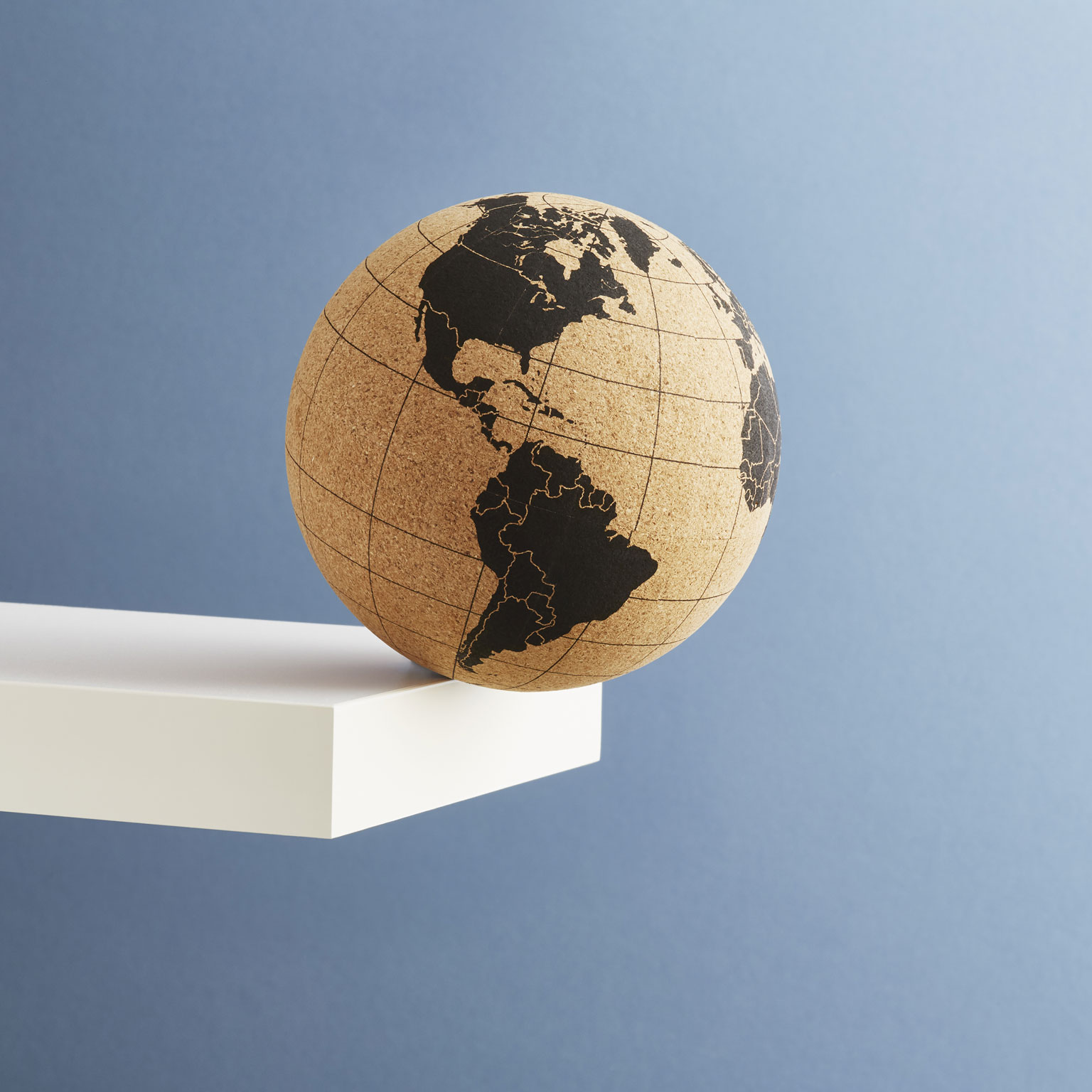 The globe in brown and yellow at the edge of a diving board