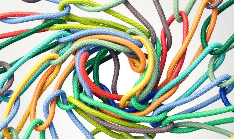 Multicolored rope rings linking together to form a vortex in the center
