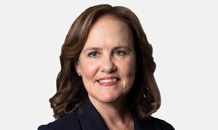 Michèle Flournoy with a light smile and a navy blazer.
