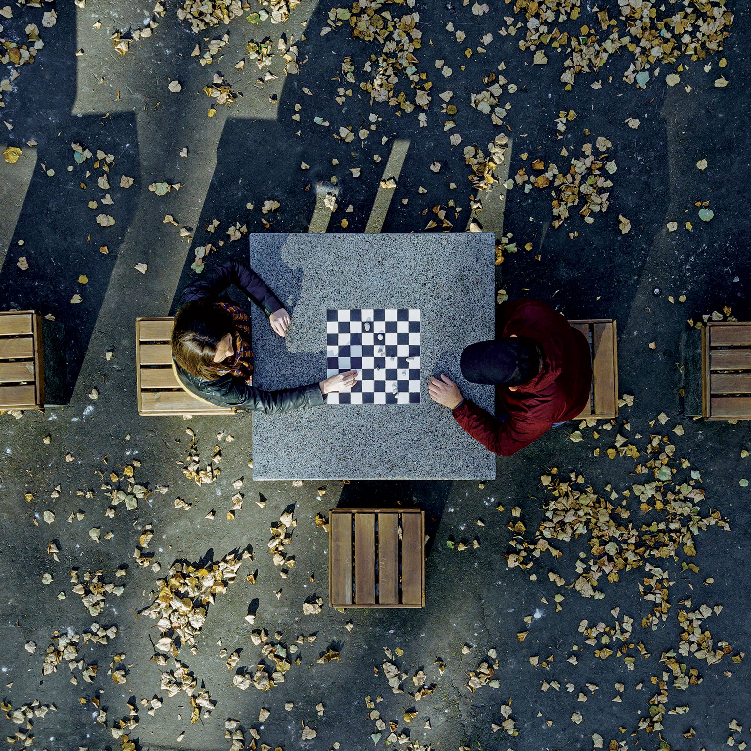Aerial view of two people playing chess outside