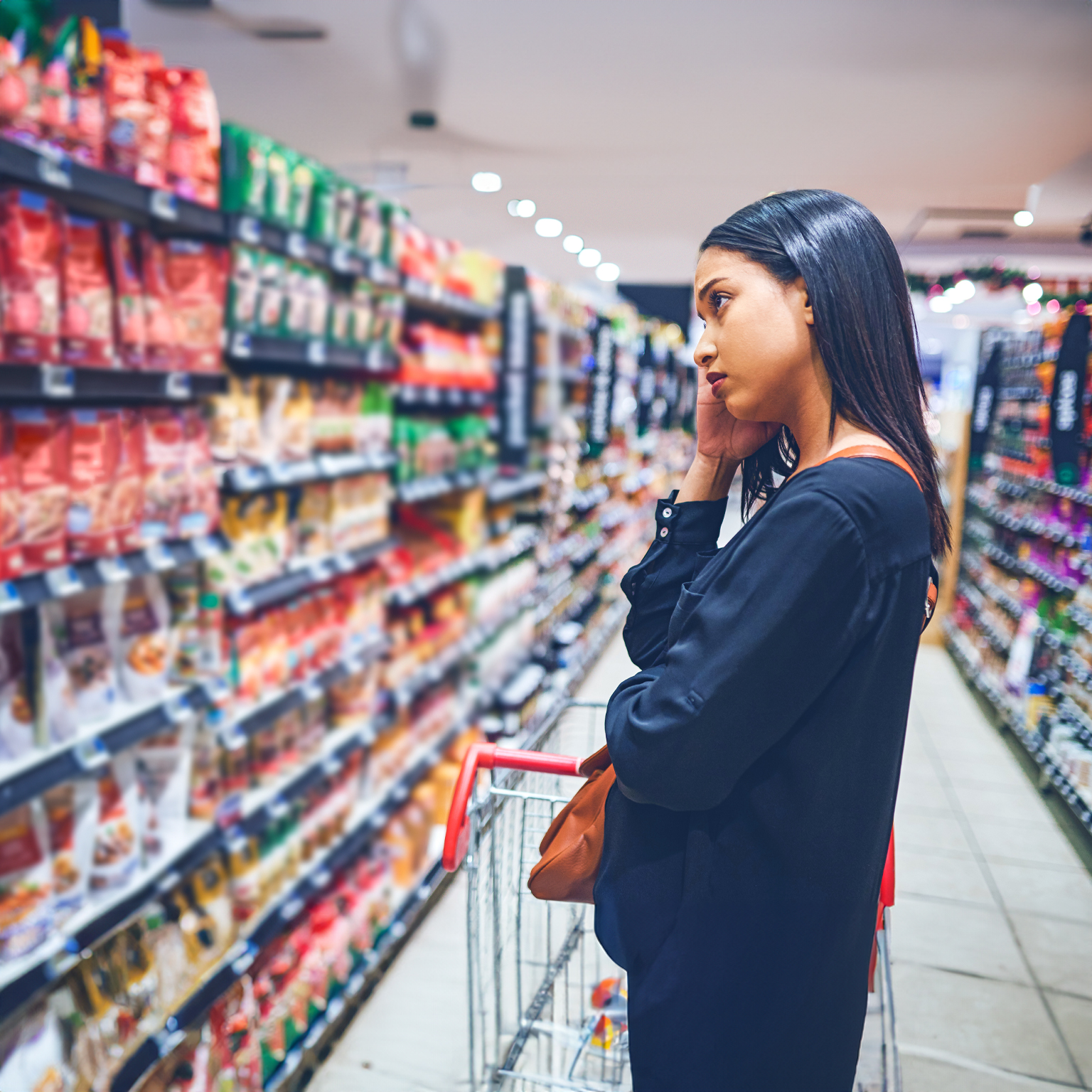 Shot of a concerned young woman shopping in a grocery store