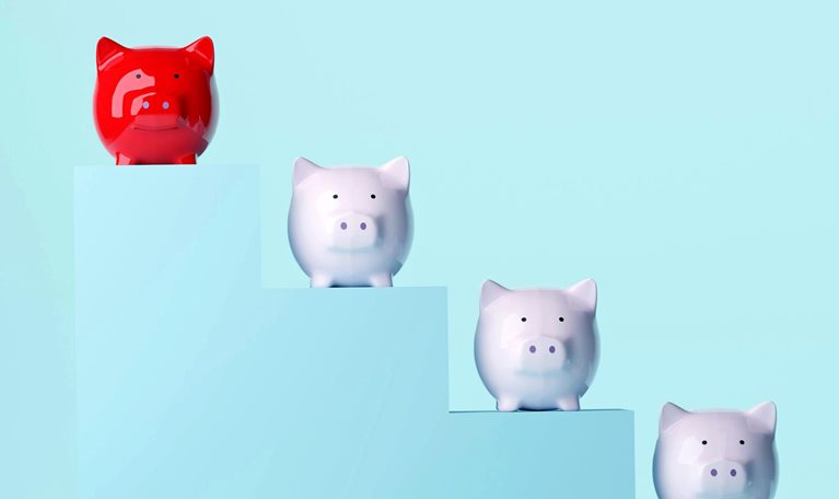 Five piggy banks descend along steps, with a red piggy bank standing apart at the top.