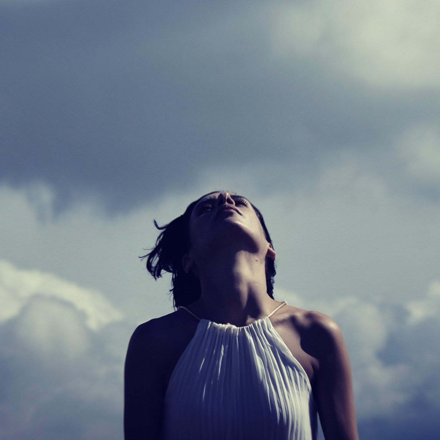 Photo of a woman inhaling outdoors without a face covering