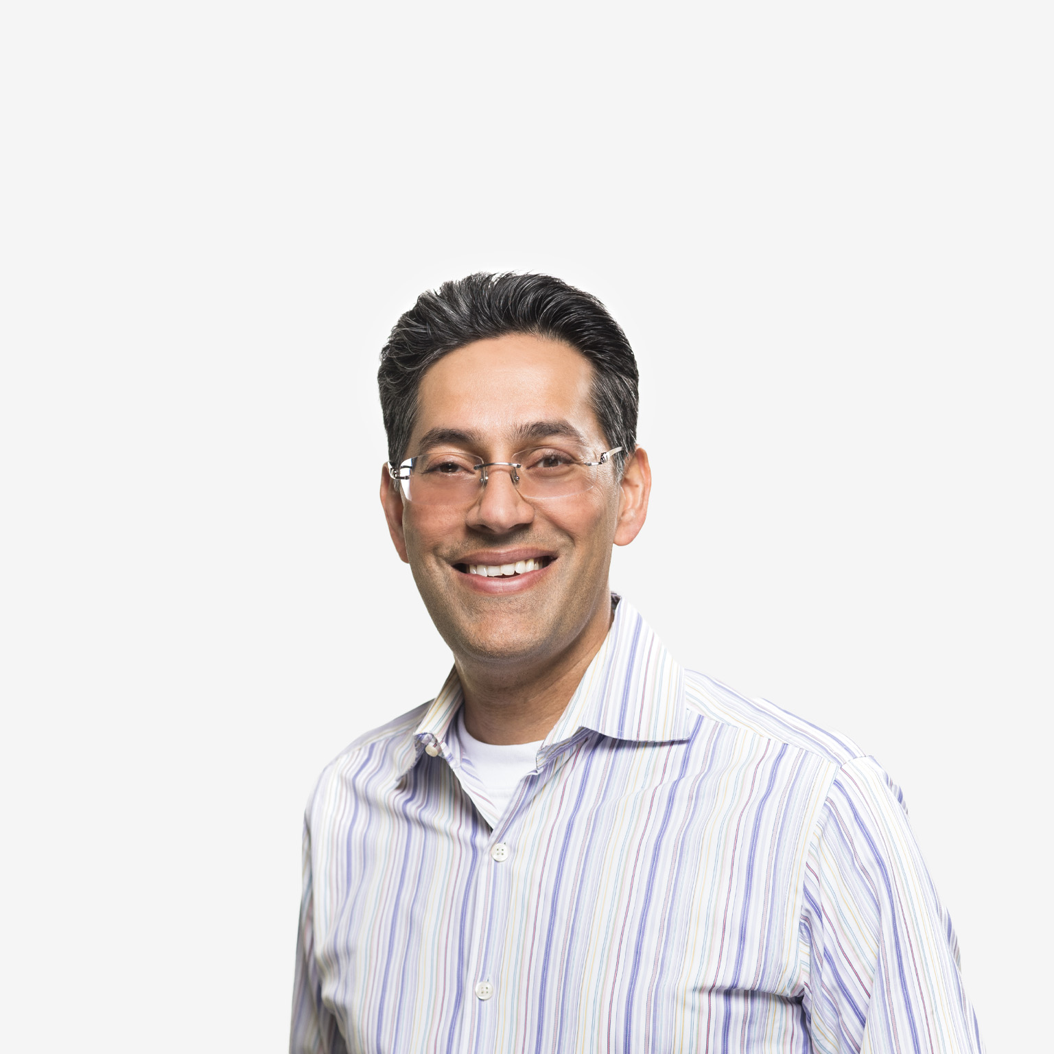 Portrait of Dipak Golechha with a friendly smile and collared shirt against a white background.