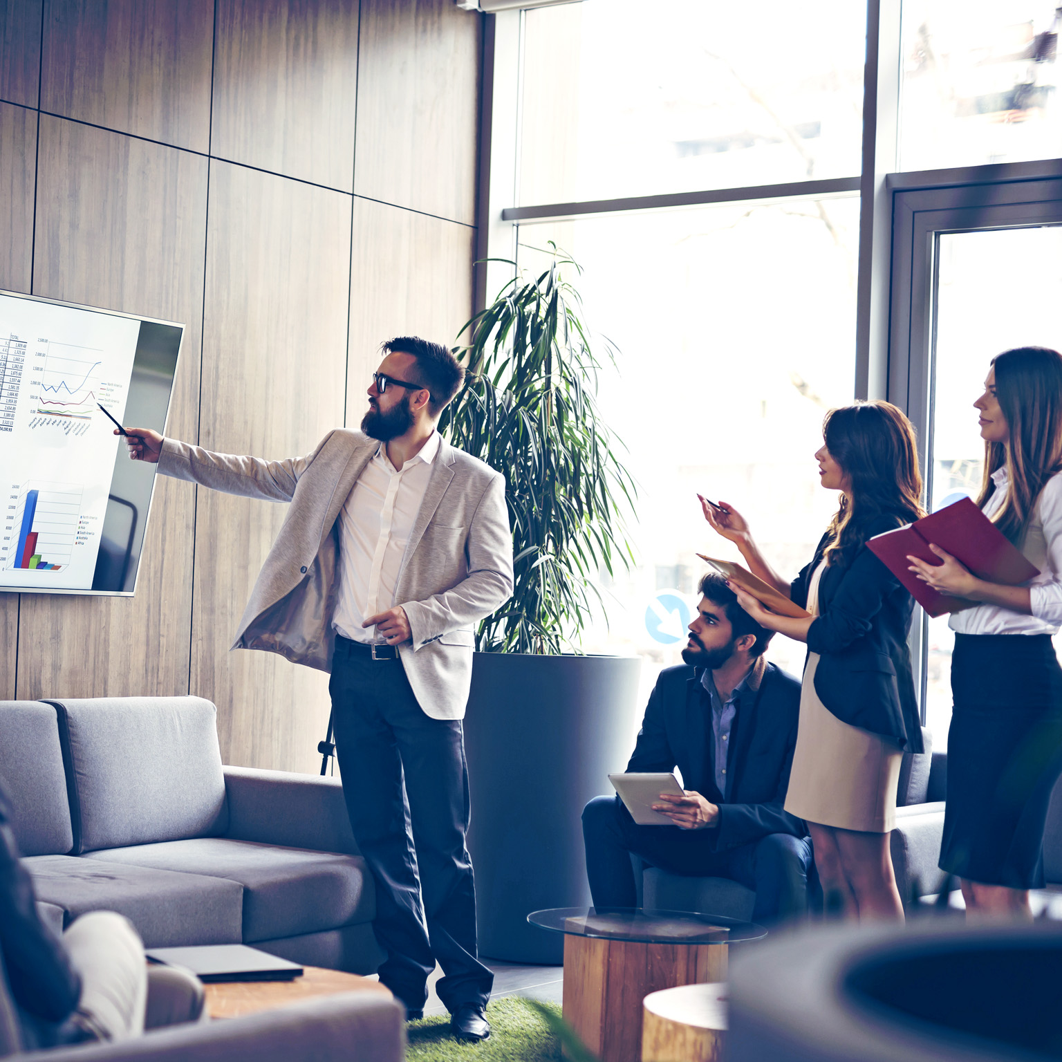 Corporate team engaged in a productive business meeting, with the Chief of Staff delivering a presentation in a contemporary office setting.