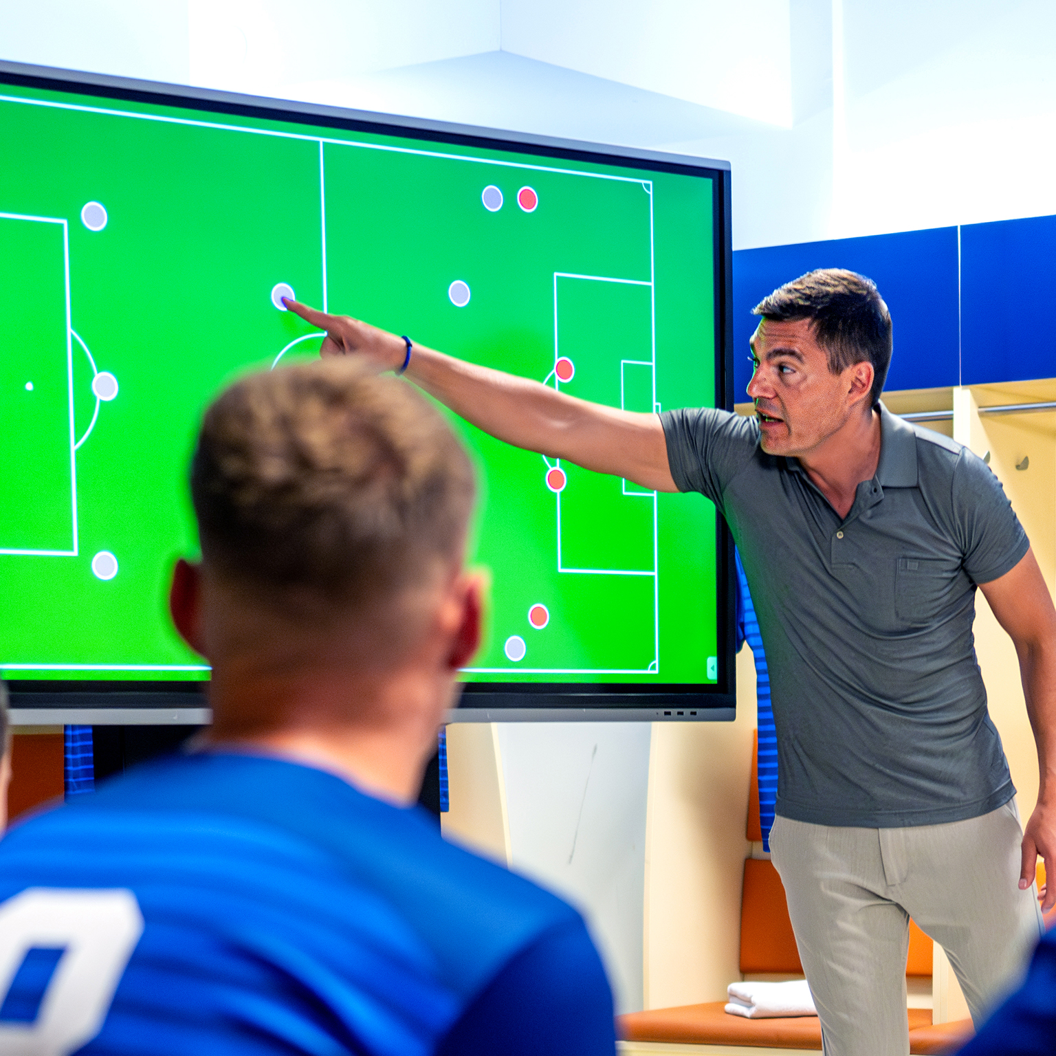 Soccer coach showing players positioning on screen