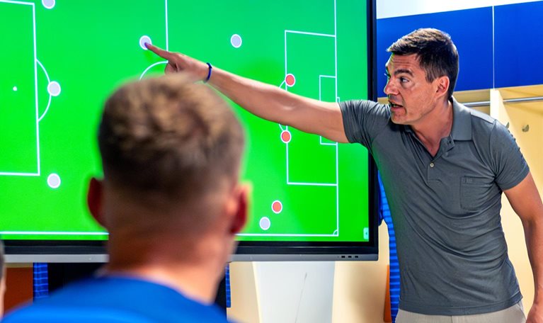 Soccer coach showing players positioning on screen