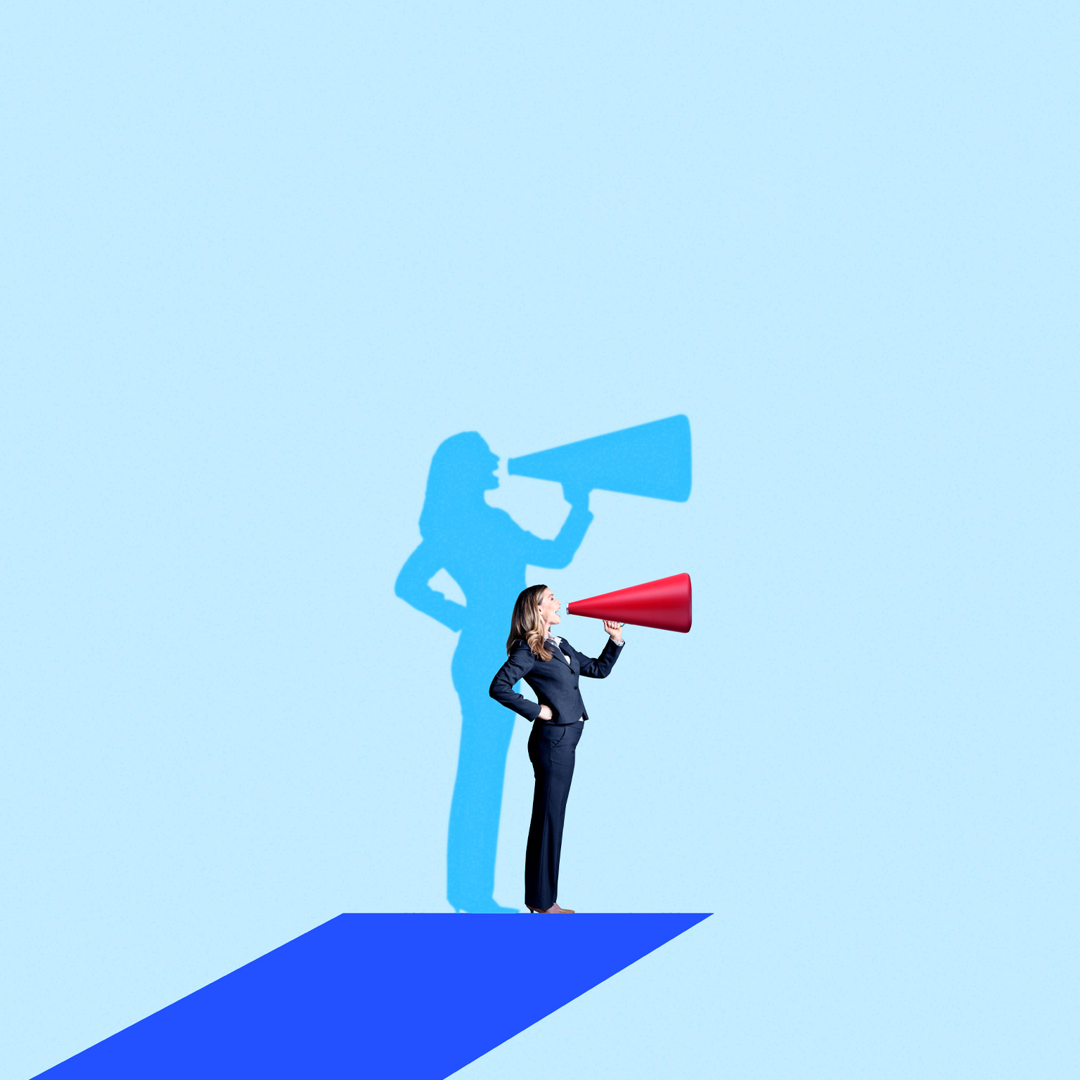 A woman in a business suit stands on a blue platform, speaking energetically into a red megaphone. Behind her, a blue shadow on the light-blue background mimics her pose, also holding a megaphone.
