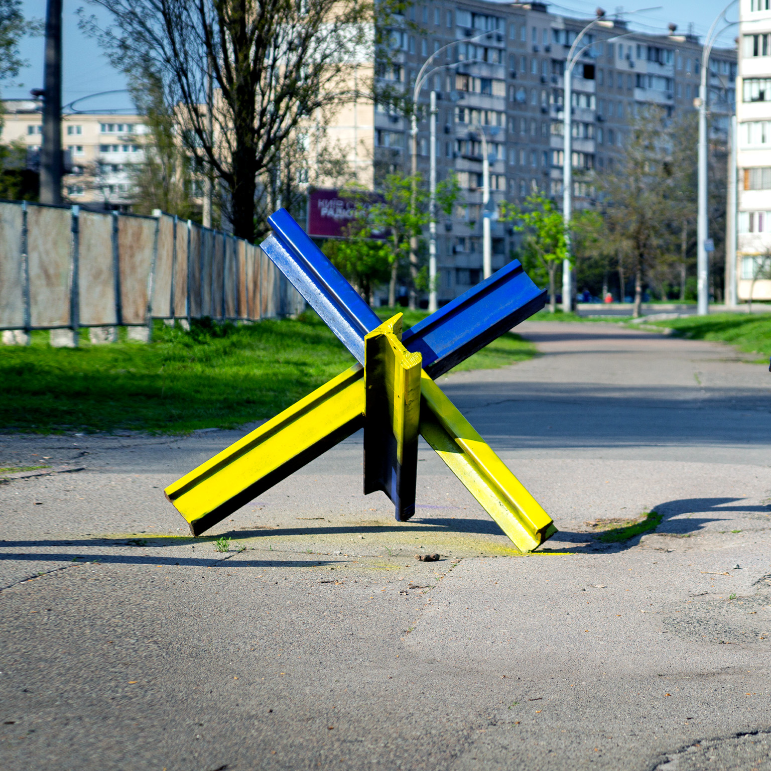 Anti-tank hedgehogs on the sidewalks of the city of Kyiv painted under the national ensign of Ukraine