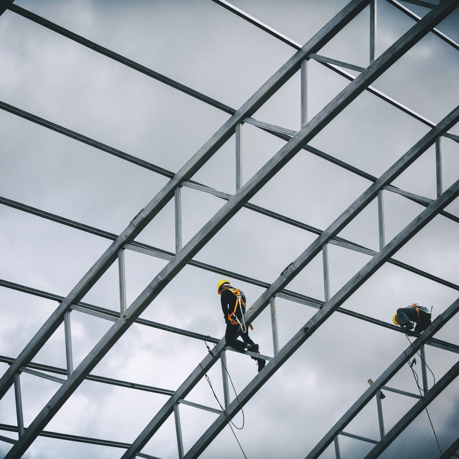 Workers standing on steel scaffolding