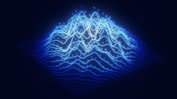 This image is a digital rendering of a futuristic wireframe landscape often used to visualize big data or sound waves. It features glowing blue lines forming hilly terrain, resembling mountains or wave patterns on a dark background. Small, scattered dots are embedded along the light trails to represent data points or particles.