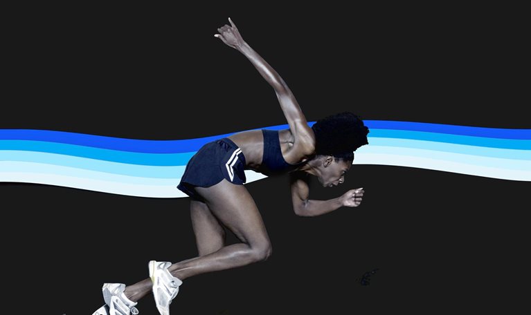 A sprinter launching powerfully from starting blocks against a dark background, her body angled forward in an explosive start. Behind her, a flowing band of layered blue and white stripes creates a sense of motion and energy.