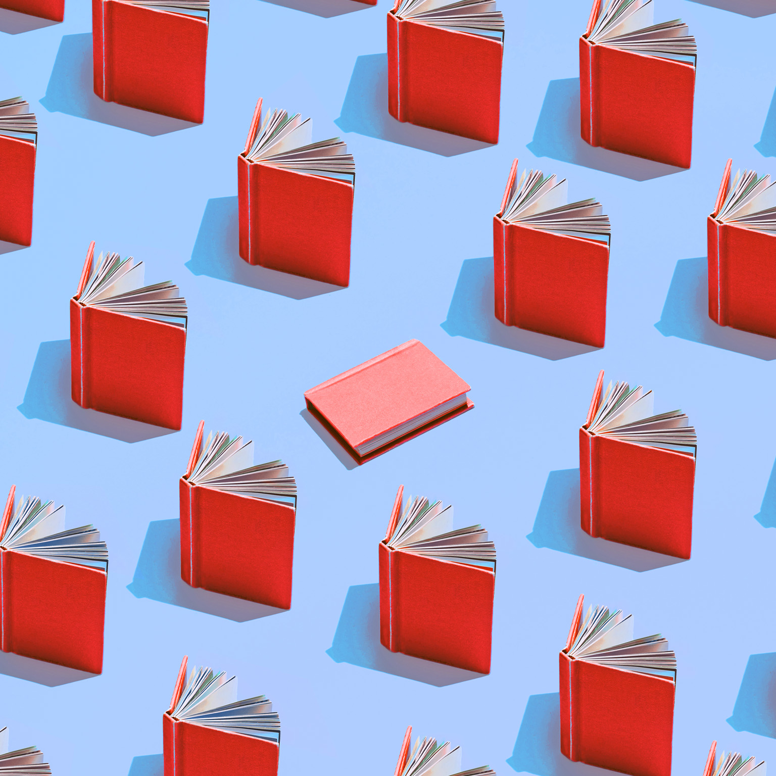 Image of multiple red books on a light blue background