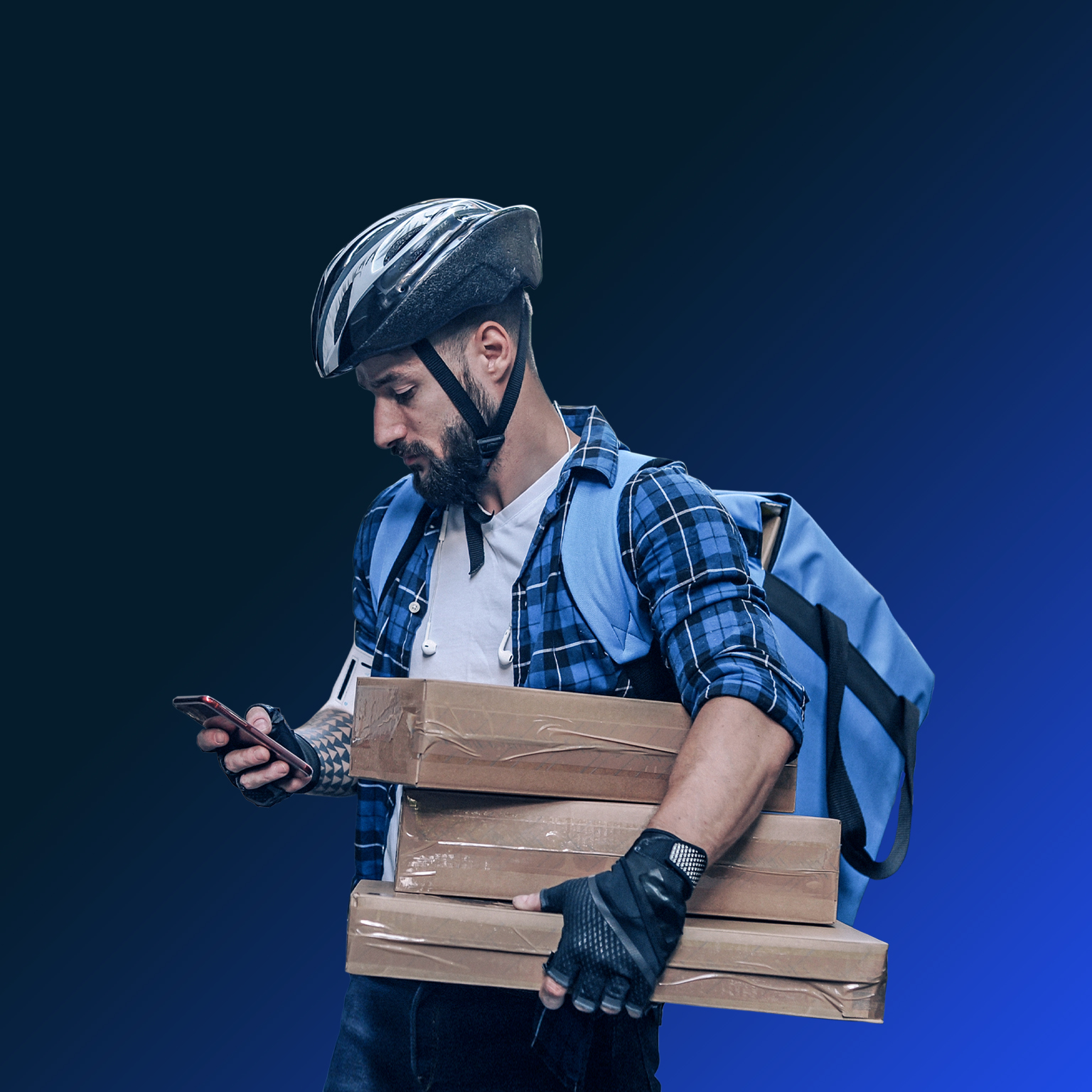 Man in biking helmet holding packages and delivery bag, looking at phone
