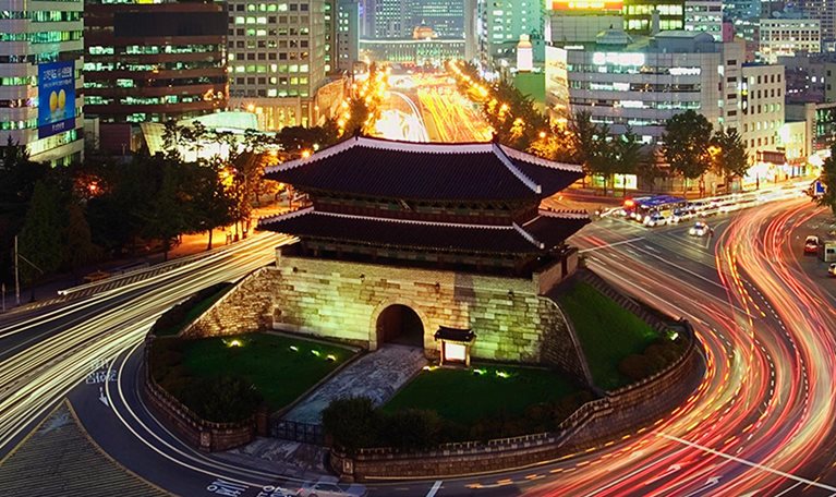 Elevated view of Namdaemun Gate and traffic at dusk in Seoul, South Korea. - stock photo