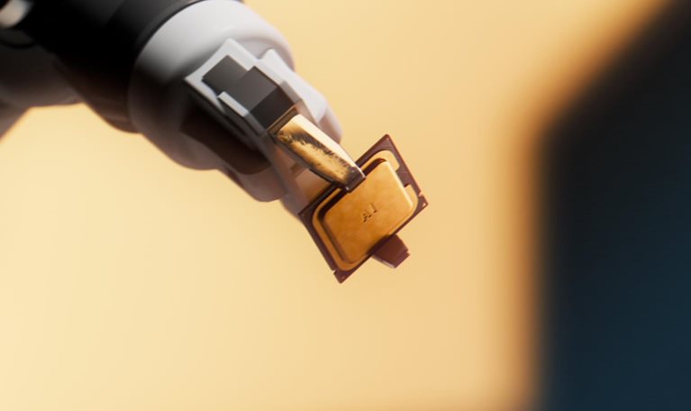 The image shows a micro-electromechanical or semiconductor component, appearing to be a miniature surface-mount electronic package or packaged sensor held by a vacuum pick-and-arm tool during automated assembly.