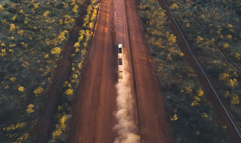Aerial image showing a road train driving on the Tanami Road, Northern Territory, Australia