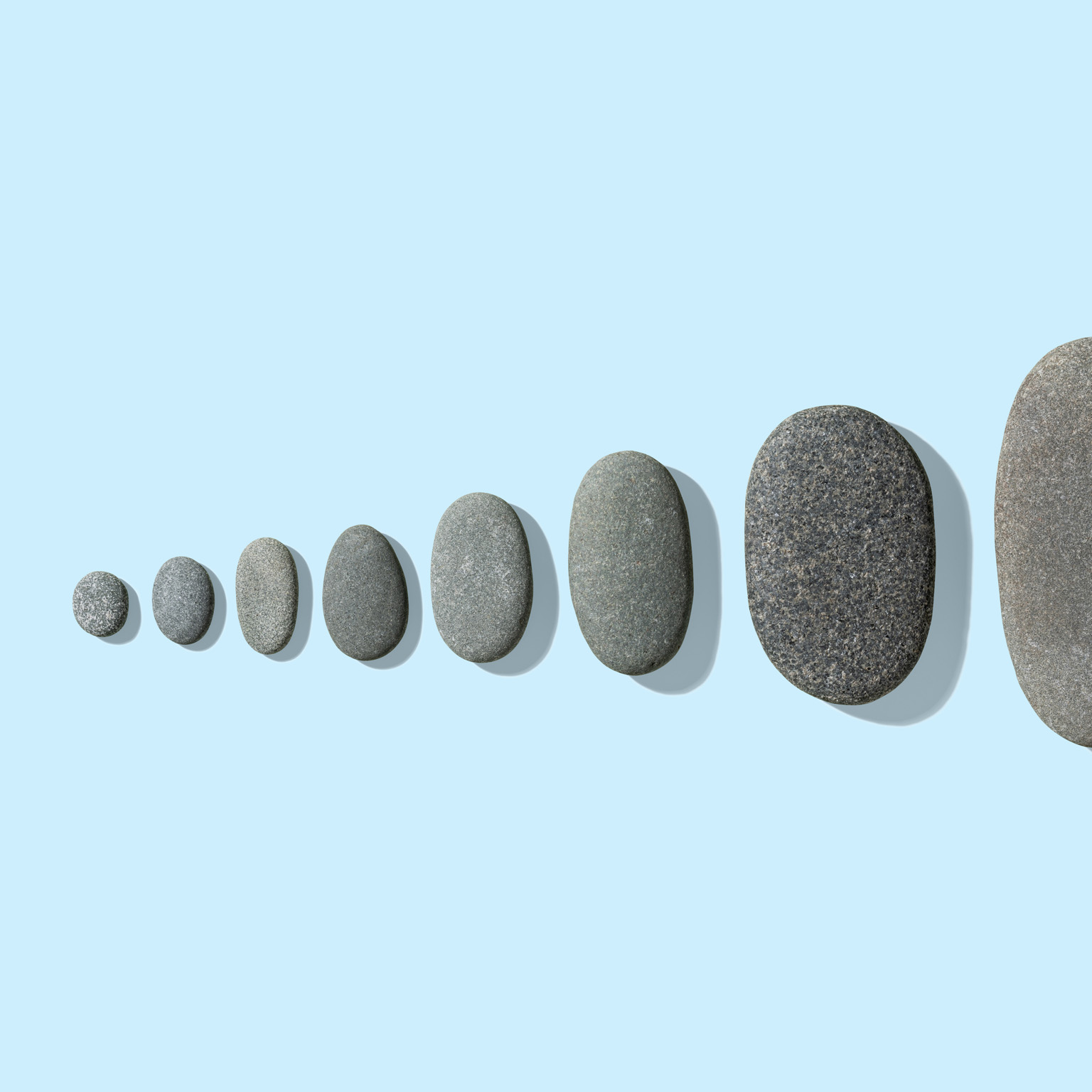 Gray pebbles neatly arranged from small to large