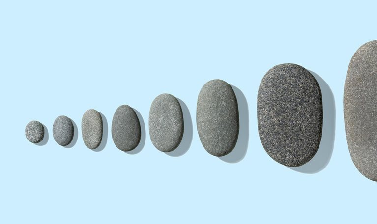 Gray pebbles neatly arranged from small to large