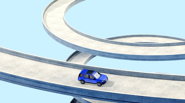 A conceptual depiction of a blue vehicle traversing a lengthy, curving pathway in a spiral form. The backdrop is a uniform, pale blue hue.