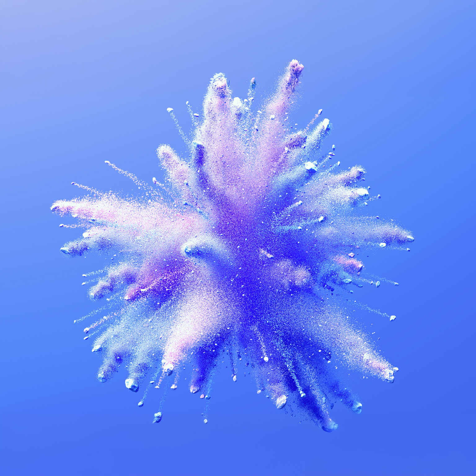A vibrant burst of fine powder in shades of blue and purple explodes outward against a soft blue background. The particles radiate in all directions, creating a dynamic, cloud-like shape.