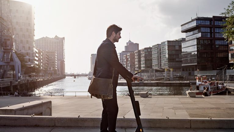 Young man on e-scooter in the city