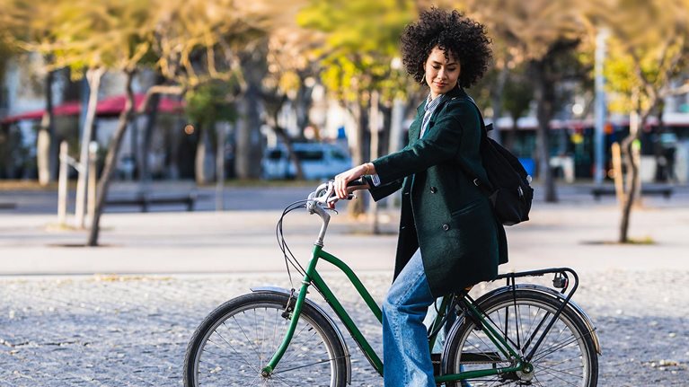 Woman riding commuter bicycle in hypothetical city. - photo