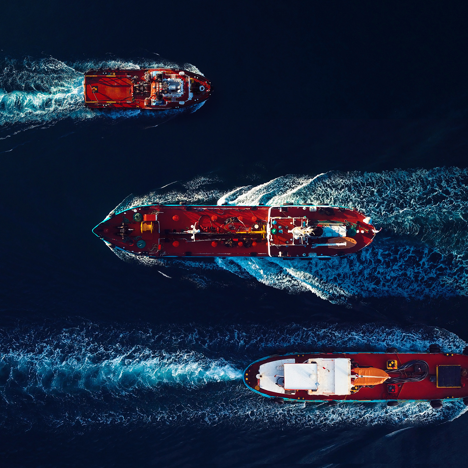 Aerial view of Oil and Gas tanker ships on the move in the harbour. - stock photo