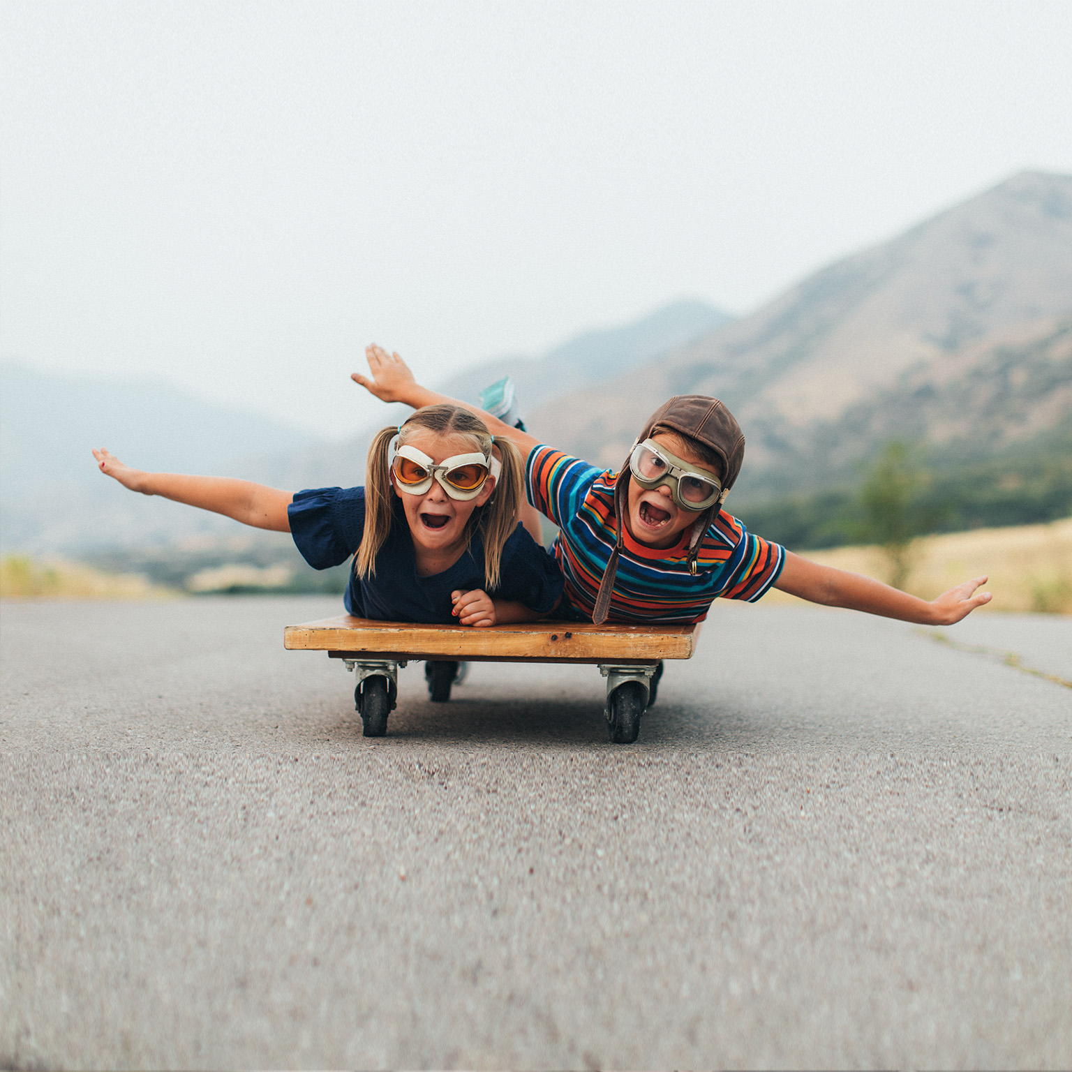 Young Kids Flying on a Press Cart - stock photo