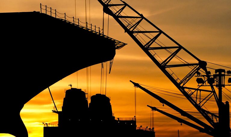 Silhouette of a ship and crane during sunset at the Philadelphia Navy Yard.