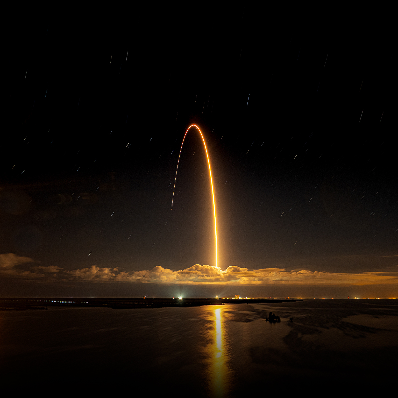 Beautiful shot of a rocket launched against a dark night sky - stock photo