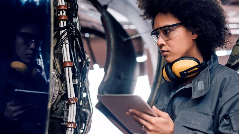 Female mechanic using digital tablet at work  - stock photo