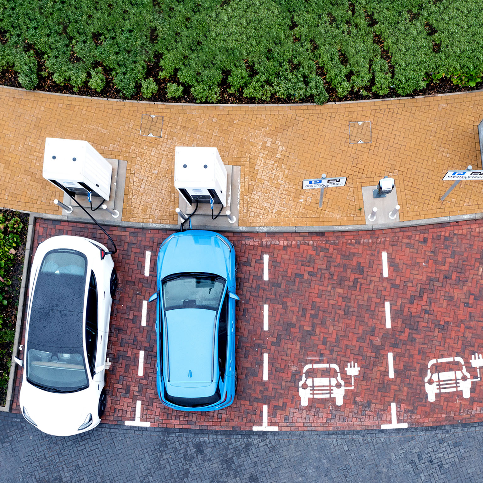 Aerial view directly above electric car being charged